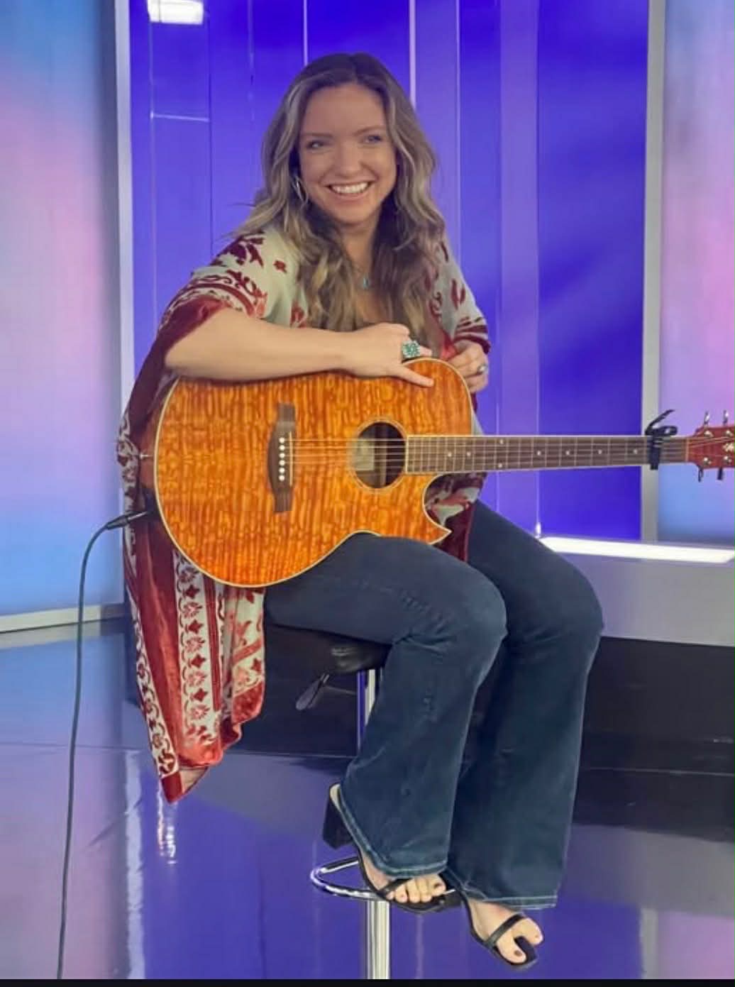 Natalie Merrill playing acoustic guitar with The Glorious Heydays